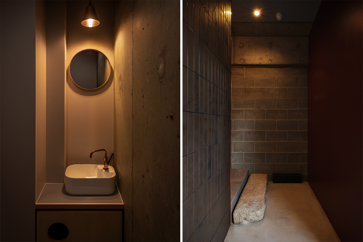 「近野」の洗面とエントランスのディテール。コンクリート壁と柔らかな照明が落ち着いた雰囲気を作る。