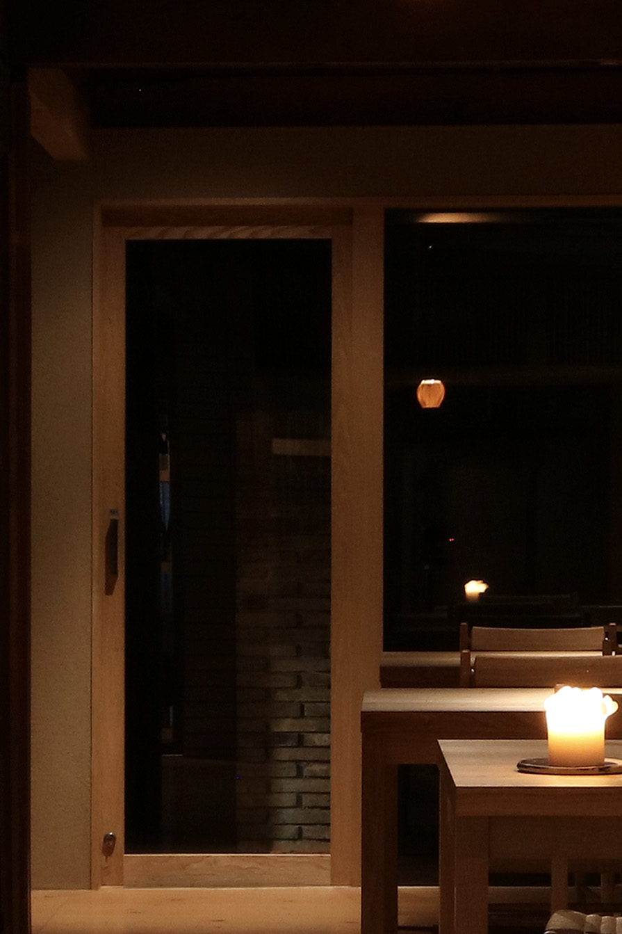 「Badu」の化粧室へと続く造作建具。扉を開けると庭が現れ、左手に化粧室が続く。